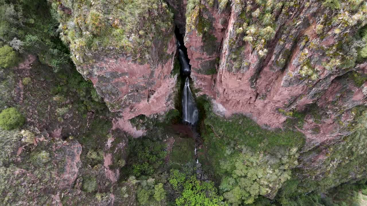 Aerial of the spectacular Perolniyoc Waterfall which is situated in the Highlands of Cusco, Urubamba, Sacred Valley, Cusco, Peru. Drone overhead orbit