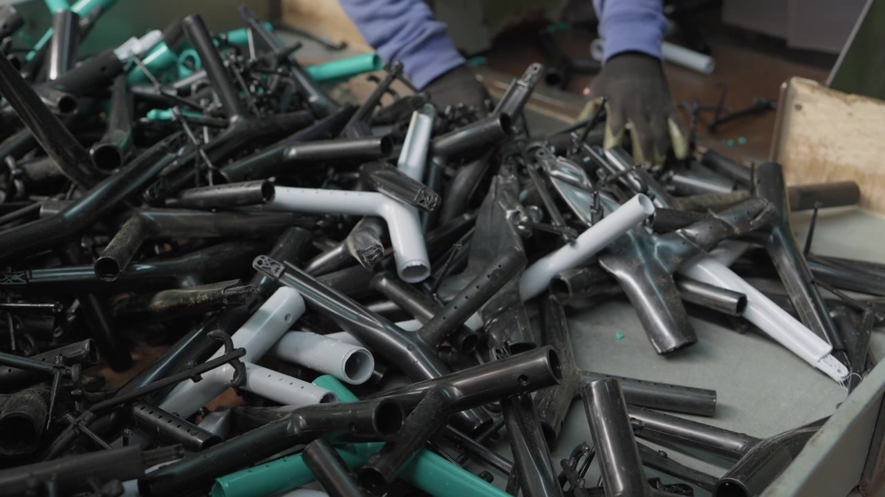 Heap of discarded plastic pipes joints and fittings collected for recycling in factory