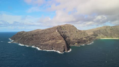 aerial fly away of the makapuu light house in waimanalo hawaii with the ocean in view