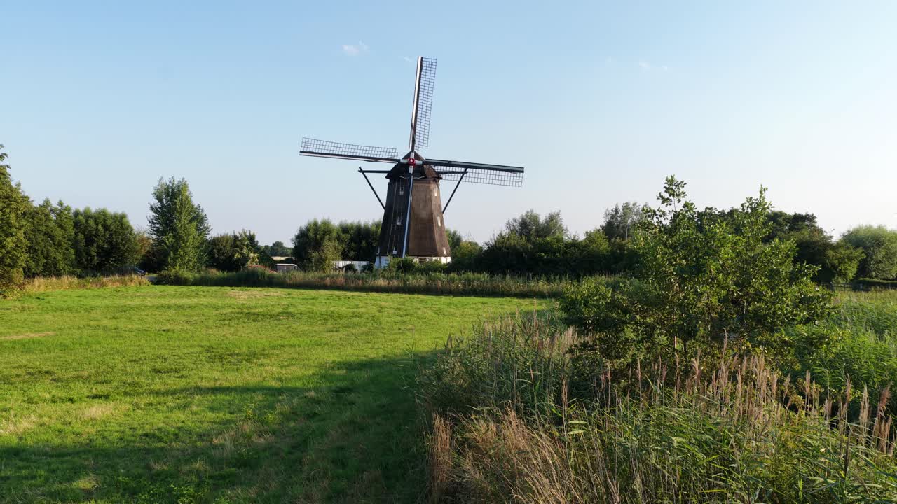 Historic wind mill, The Netherlands. Dutch culture, architecture. Green nature. Aerial video