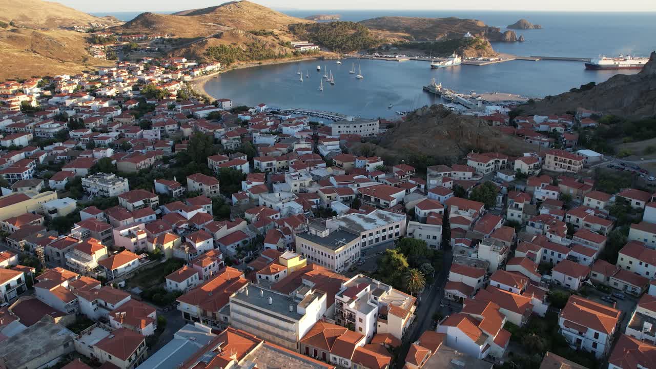 Aerial Dolly in Myrina Coastal Capital of Limnos Greece, Drone View of Traditional Houses and Port