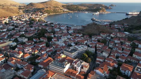 aerial dolly in myrina coastal capital of limnos greece, drone view of traditional houses and port