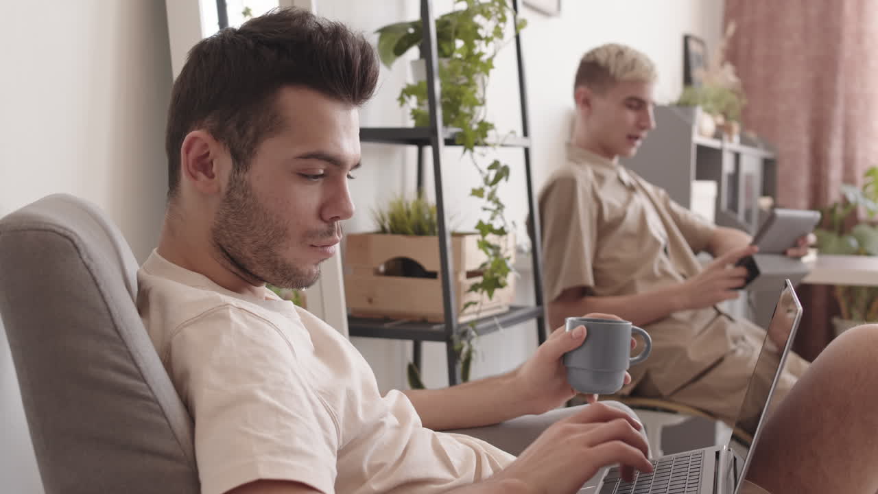 Two Young Caucasian Men Spending Weekend at Home