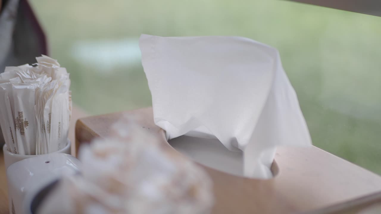 Close-up of a tissue box and other containers on a table