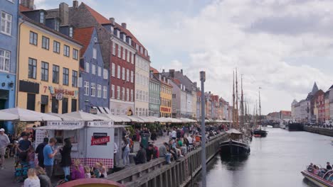 large public gathering event near nyhavn canal and buildings, copenhagen
