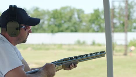 sportsman shoots from a double-barreled shotgun, a sports field for a shooting test is shooting at flying skeet