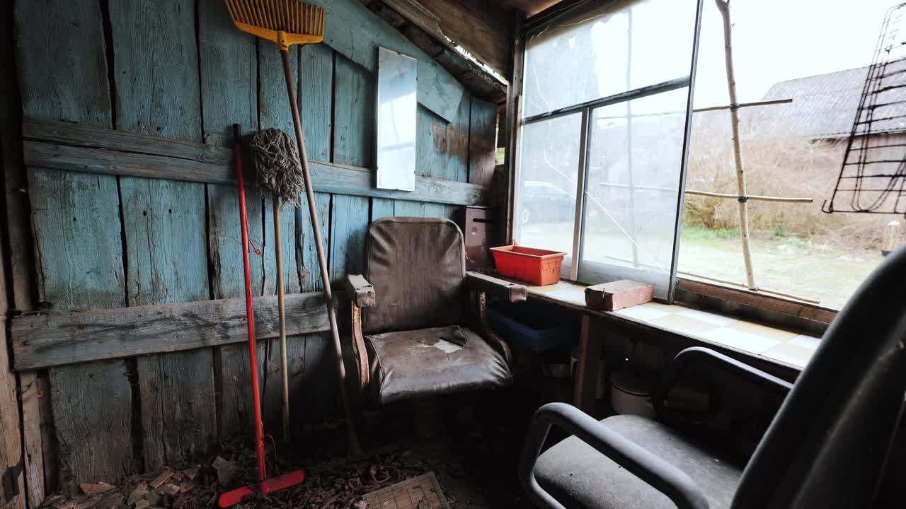 Shed corner with window, chair, broom and mop captures rural silence, inner calm