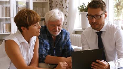 Senior-couple-planning-their-investments-with-financial-advisor