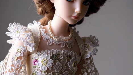 close-up of a doll wearing a lace dress