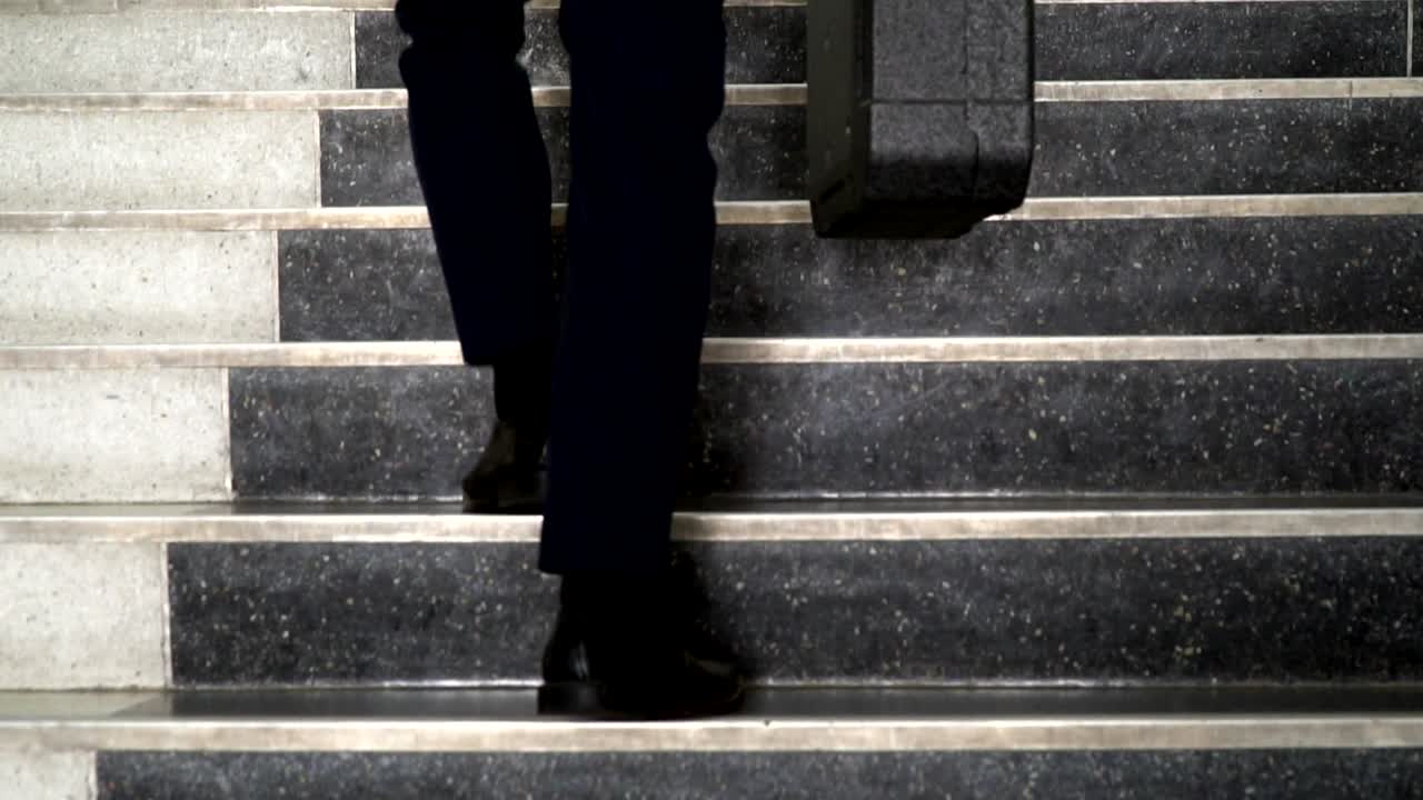 Businessmen wearing black suit went forward.
