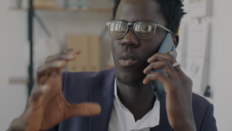 businessman talking on smartphone in office