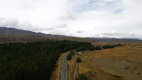 Aerial-forward-view-over-a-beautiful-road-through-a-valley