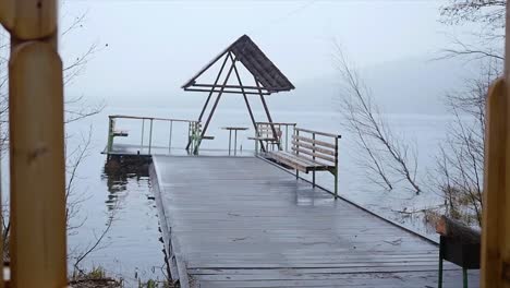 rainy lakeside pier with gazebo