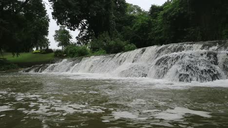 Fast-rushing-white-water-over-rocks-waterfall-and-river-in-Thailand