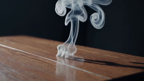 smoke rising from a wooden surface