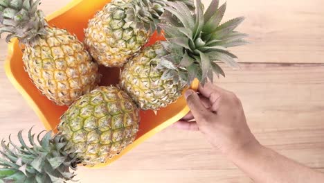 pineapples in an orange bowl