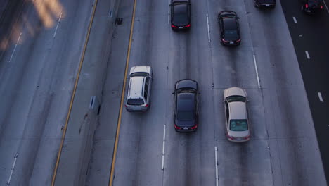 Aerial-birdseye-drone-shot-from-a-busy-highway-with-a-lot-of-traffic-on-the-roads-and-a-traffic-jam