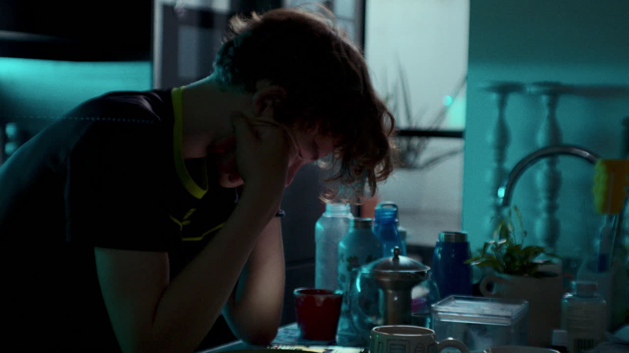 Teen boy sitting at kitchen table