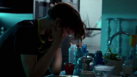 teen boy sitting at kitchen table