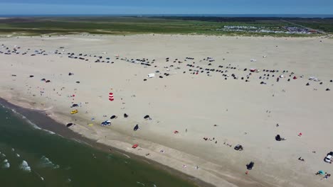 Drone-shot-busy-crowded-beach-on-coast-of-Romo-Island-in-Denmark