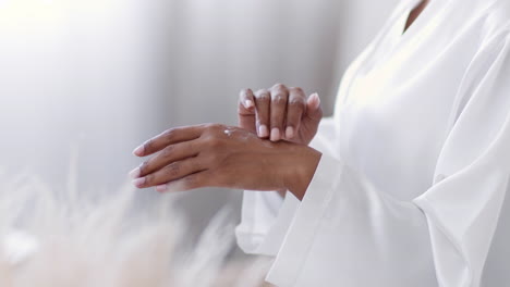 woman applying lotion to wrist