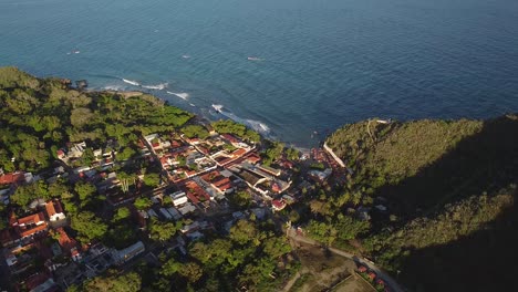 Aerial-shot-of-Puerto-Colombia-and-El-Malecón,-Aragua-State,-Venezuela,-high-angle-backward-shot