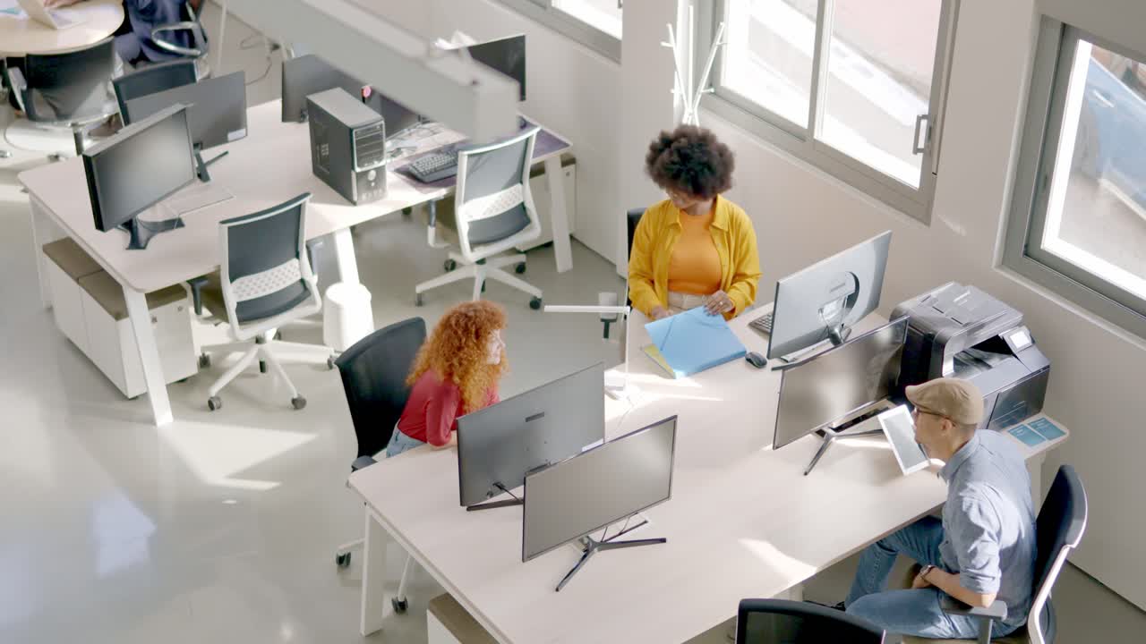 Top view of coworkers chatting sitting in the office
