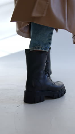 stylish fall/winter outfit with black boots and trench coat