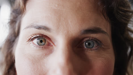 Portrait-of-happy-eyes-of-caucasian-casual-businesswoman-in-office,-slow-motion