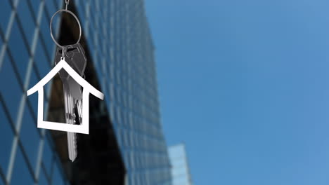 animation of silver house key and jey fob over cityscape