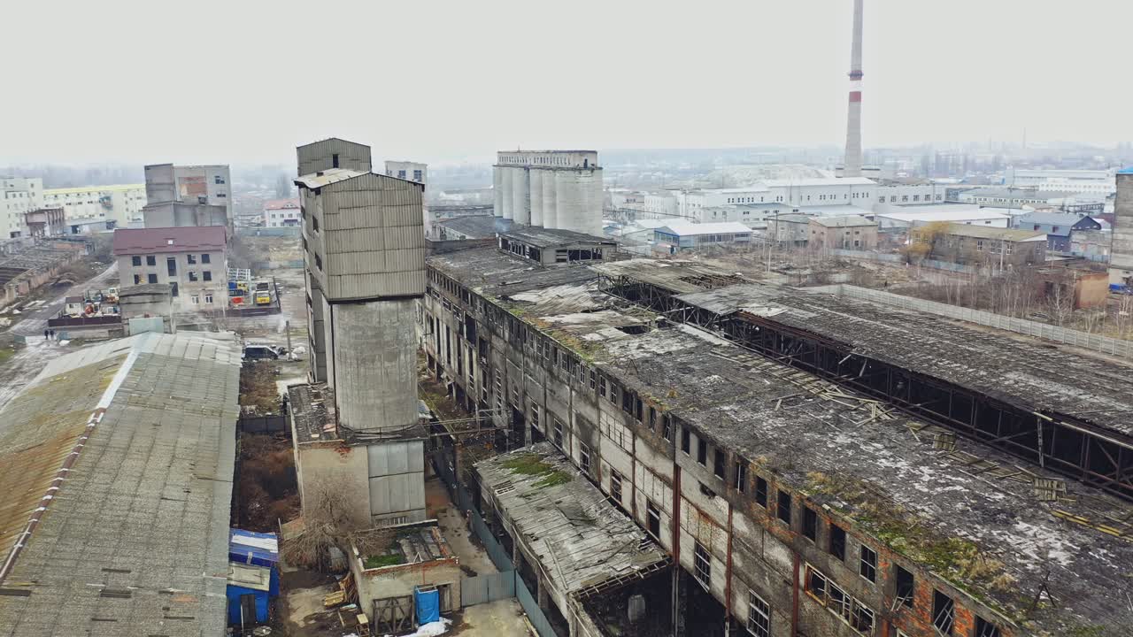 Aerial view of an old factory ruin and broken windows. Old industrial building for demolition.