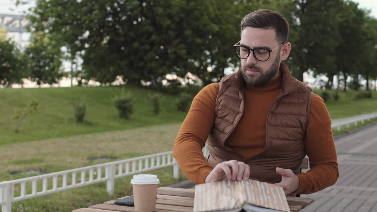 Man Taking Call at Outdoor Table