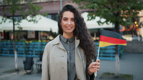 woman holding german flag in city street