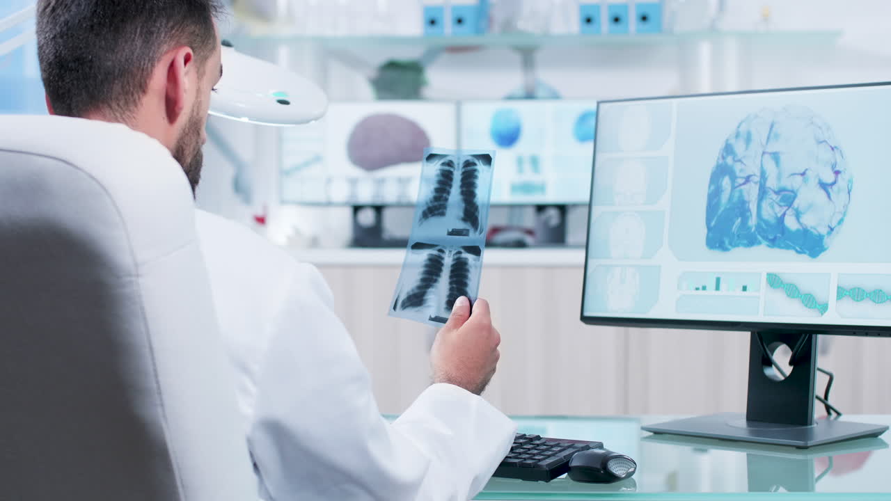Doctor analyzing x-rays and brain scans on a monitor