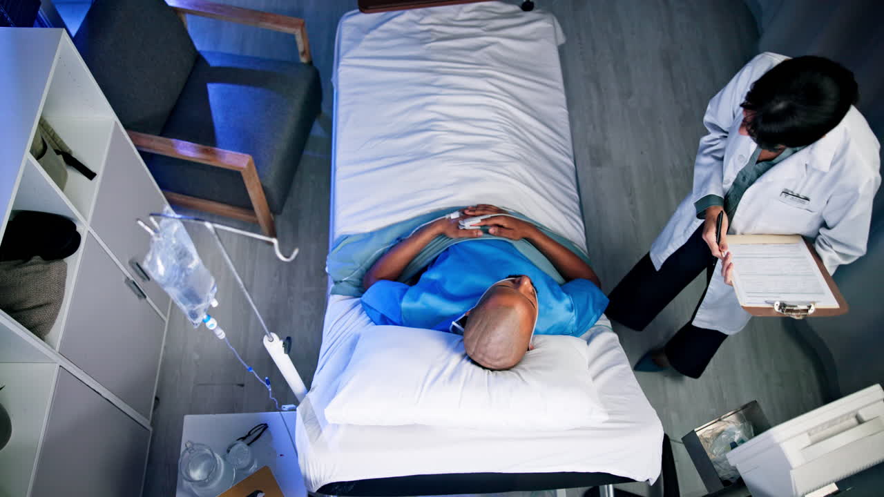 Doctor Examining Patient in Hospital Bed