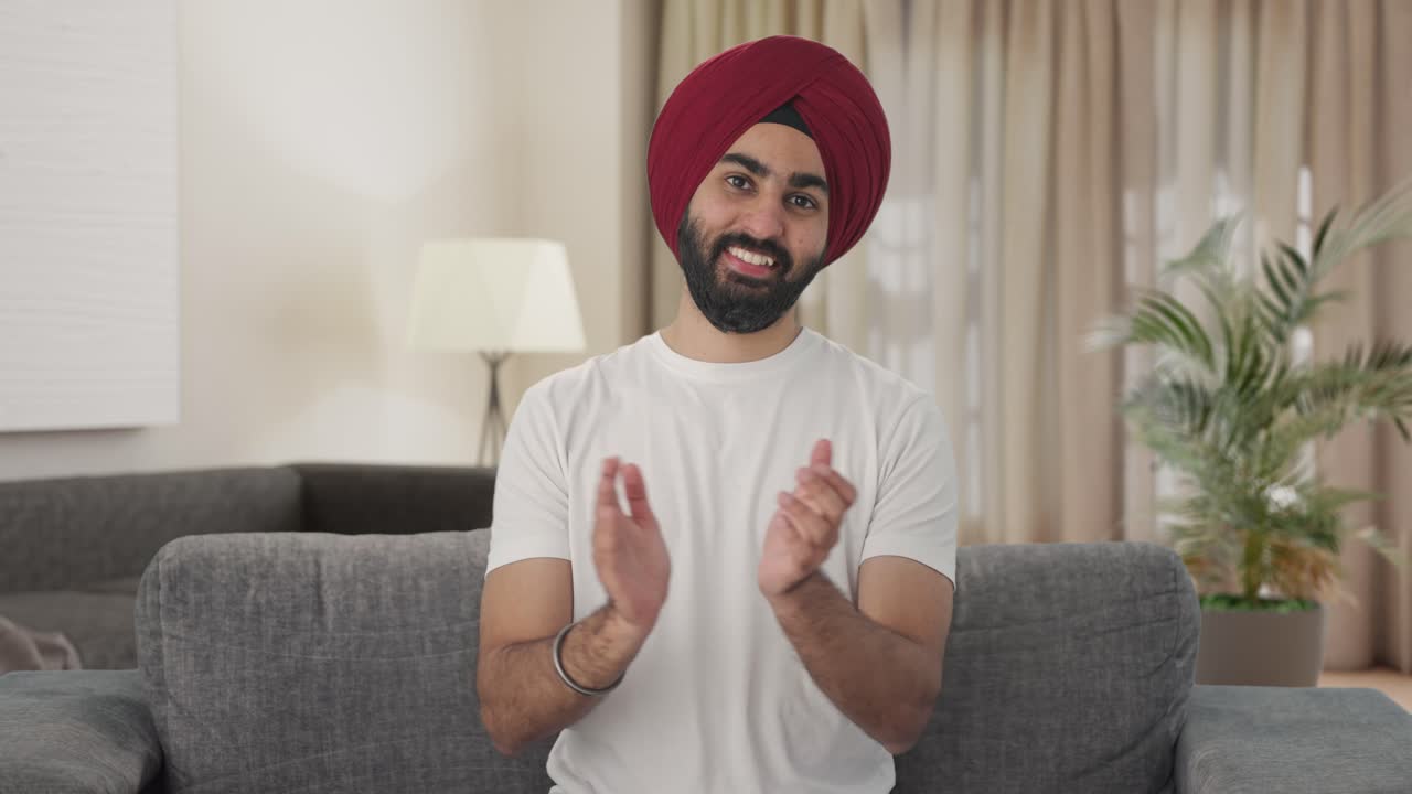Uomo Sikh indiano felice che applaude e manifesta apprezzamento