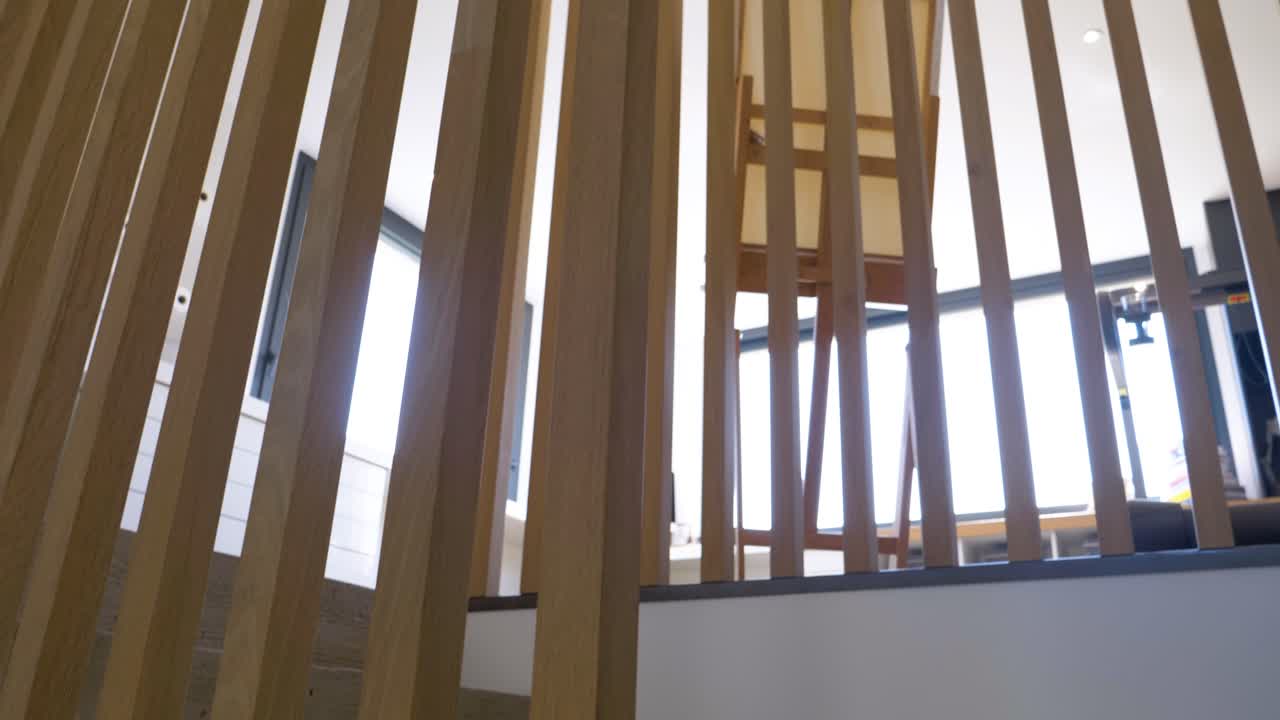 Slow establishing shot within a villa showing vertical wooden paneling and a map