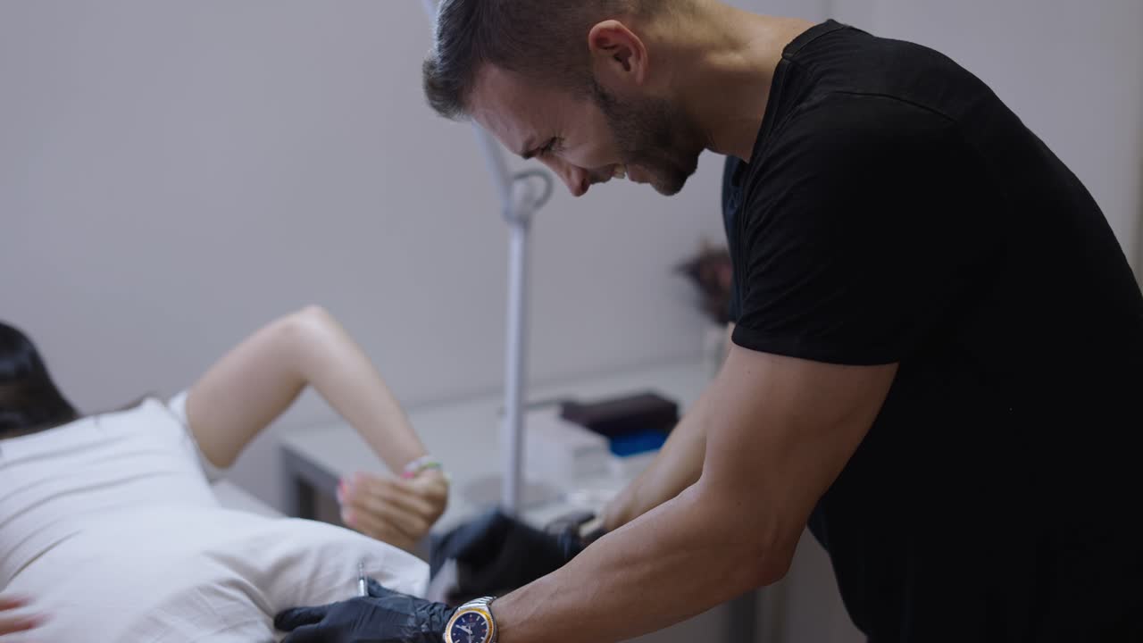 Professional Performing a Leg Treatment in a Clinic
