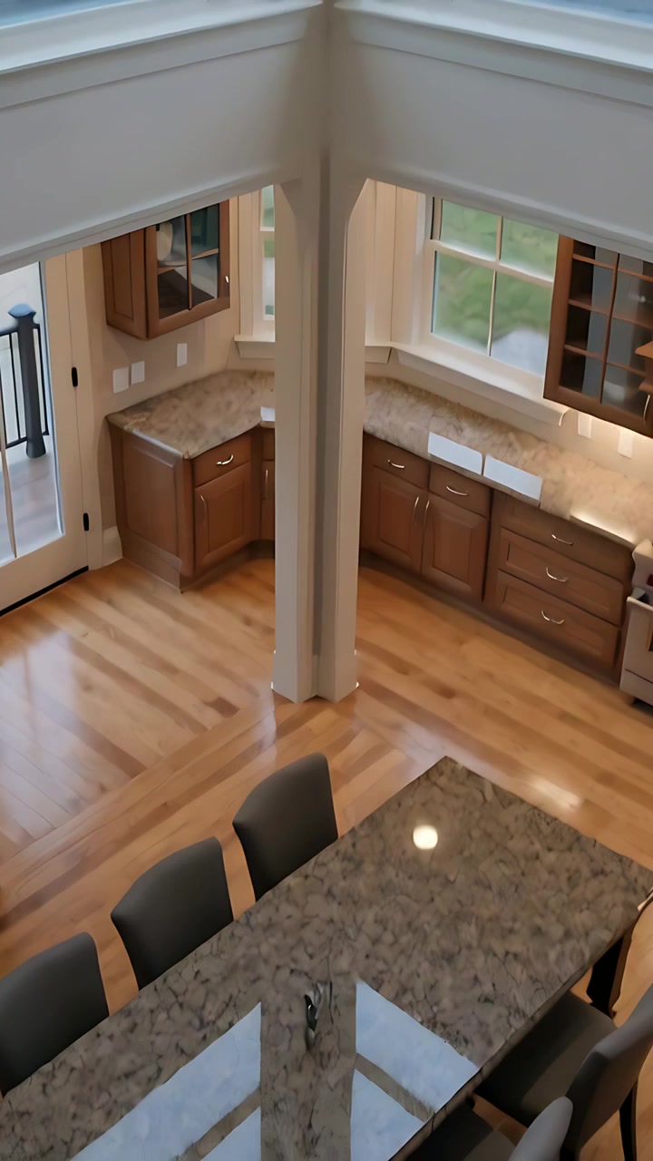 Vertical video: Camera tilting panning center column and bay windows revealing island tap at home