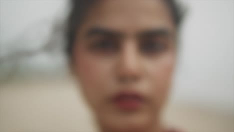 cinematic close up of the face of an indian fashion model wearing a nose ring in goa, india, slow motion