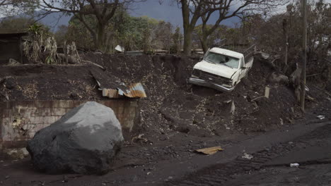 wide shot of a truck destroyed in the pyroclastic flow following fuego volcanic eruption in guatemala