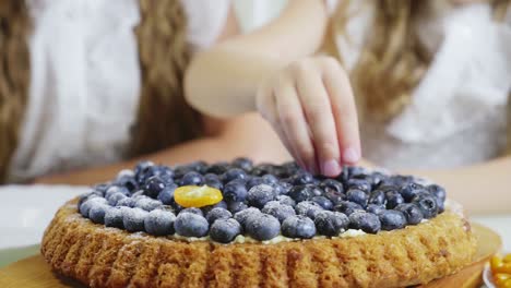 kids enjoying a blueberry tart