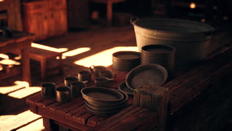 old rustic kitchen with metal dishes and a bucket