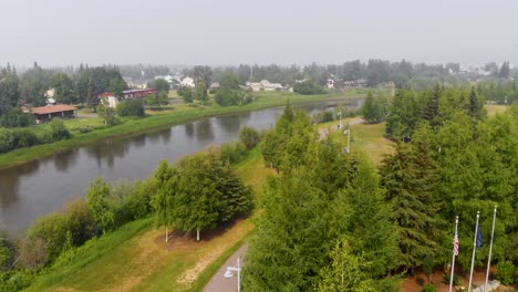 4k drone video of the chena river running through downtown fairbanks, alaska during summer day