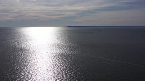 a very slow - dramatic pull away over the atlantic ocean on a windless morning