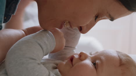 close up happy mother playing with baby at home loving mom nurturing toddler having fun parent bonding with child enjoying motherhood childcare