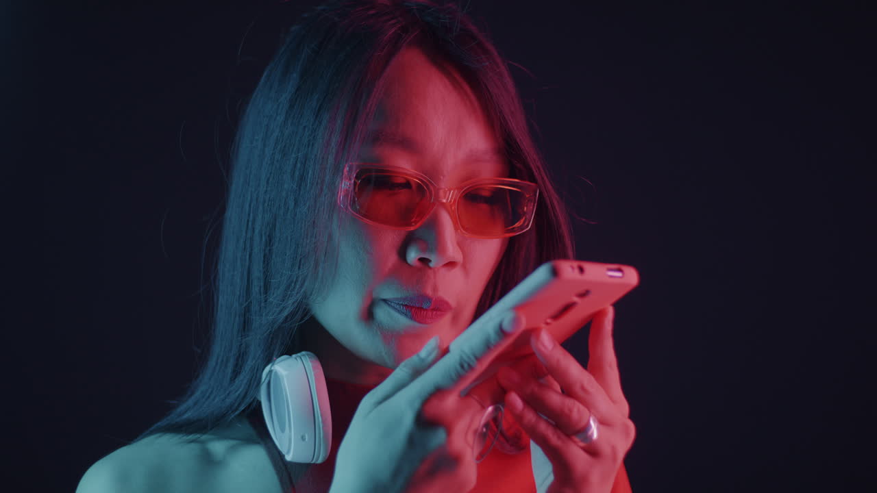 Woman Using Smartphone with Neon Lighting