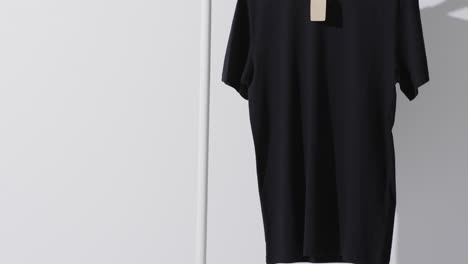 video of black t shirt on hanger and copy space on white background