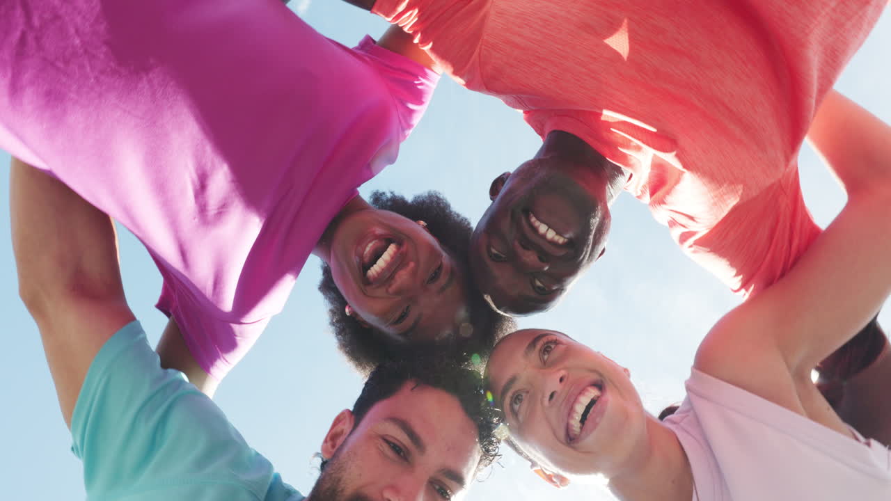Happy Diverse Group of Friends Huddling and Smiling Together