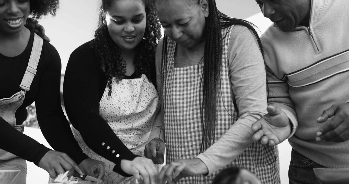 Multi-Generational African American Family Cooking Together in Kitchen